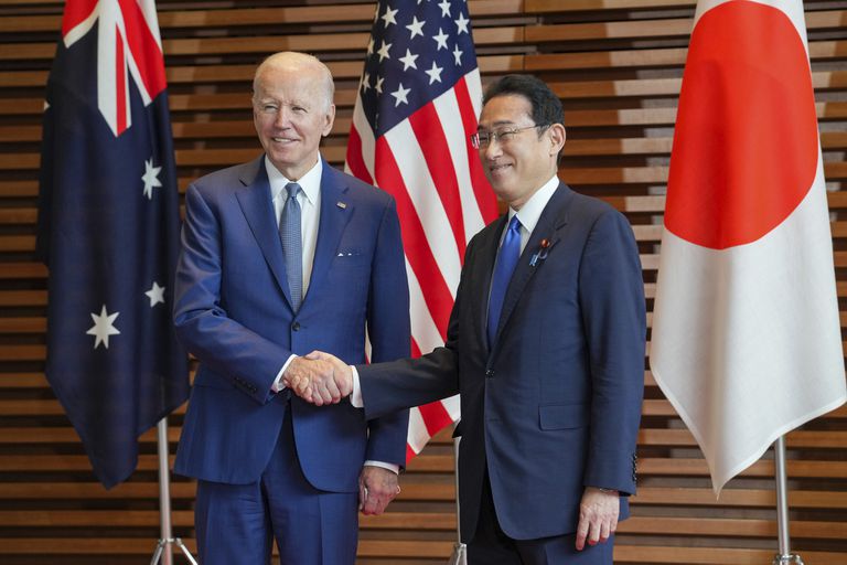 U.S. President Joe Biden, left, is welcomed by Japan s Prime Minister Fumio Kishida, at the entrance hall of the Prime Minister s Office of Japan in Tokyo, Japan, Tuesday, May 24, 2022. Leaders of the U.S., Japan, Australia and India gathered in Tokyo on Tuesday for a summit of the Quad.  (Zhang Xiaoyu/Pool Photo via AP